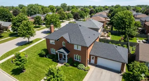 Aerial view of a residential home with a new charcoal asphalt shingle roof